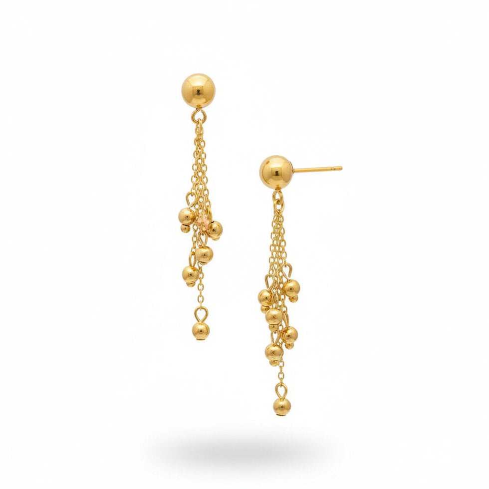 A pair of gold dangle earrings with spherical beads and delicate chains, shown against a plain white background.