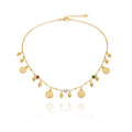 A delicate gold chain necklace with multiple dangling coin charms, small bead drops, and three colorful gemstone accents (red, green, and clear), displayed on a clean white background with a soft reflection below.
